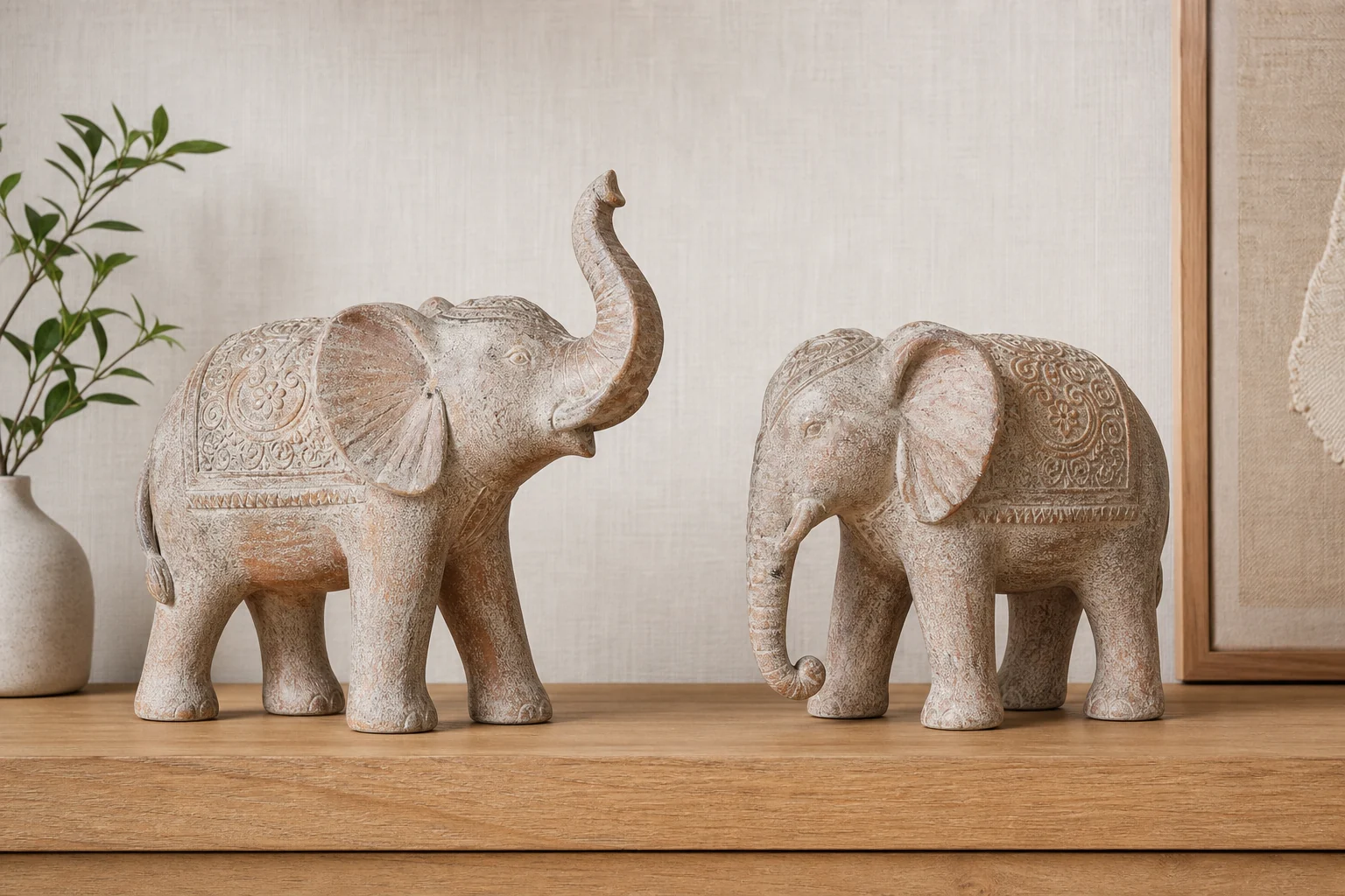 Two elephant figurines showing raised and lowered trunk positions